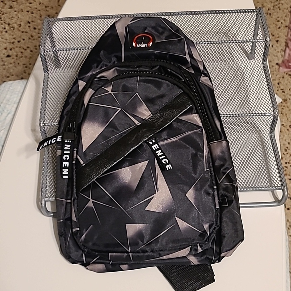 Small Sling Backpack/ Crossbody bag NWOT w/ headphone jack